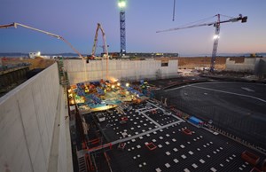 For approximately ten hours a continuous flow of concrete poured from two long pumps—800 cubic metres in all for a corner of the basemat that measures 21 x 26 metres. (Click to view larger version...)